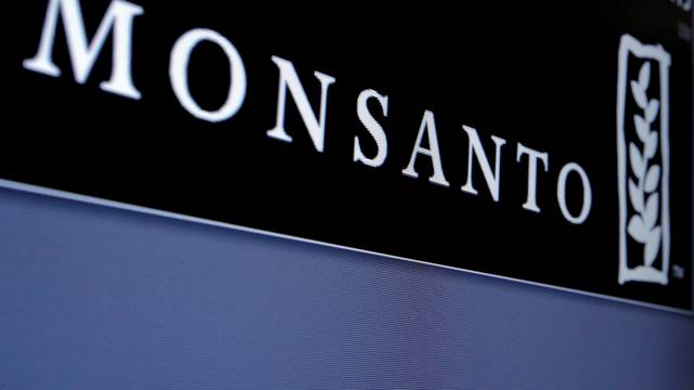 Monsanto logo is displayed on a screen where the stock is traded on the floor of the NYSE