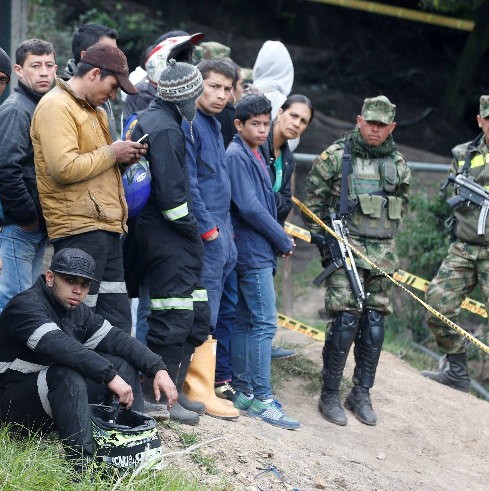 People wait for news after an explosion at an underground coal mine on Friday, in Cucunuba