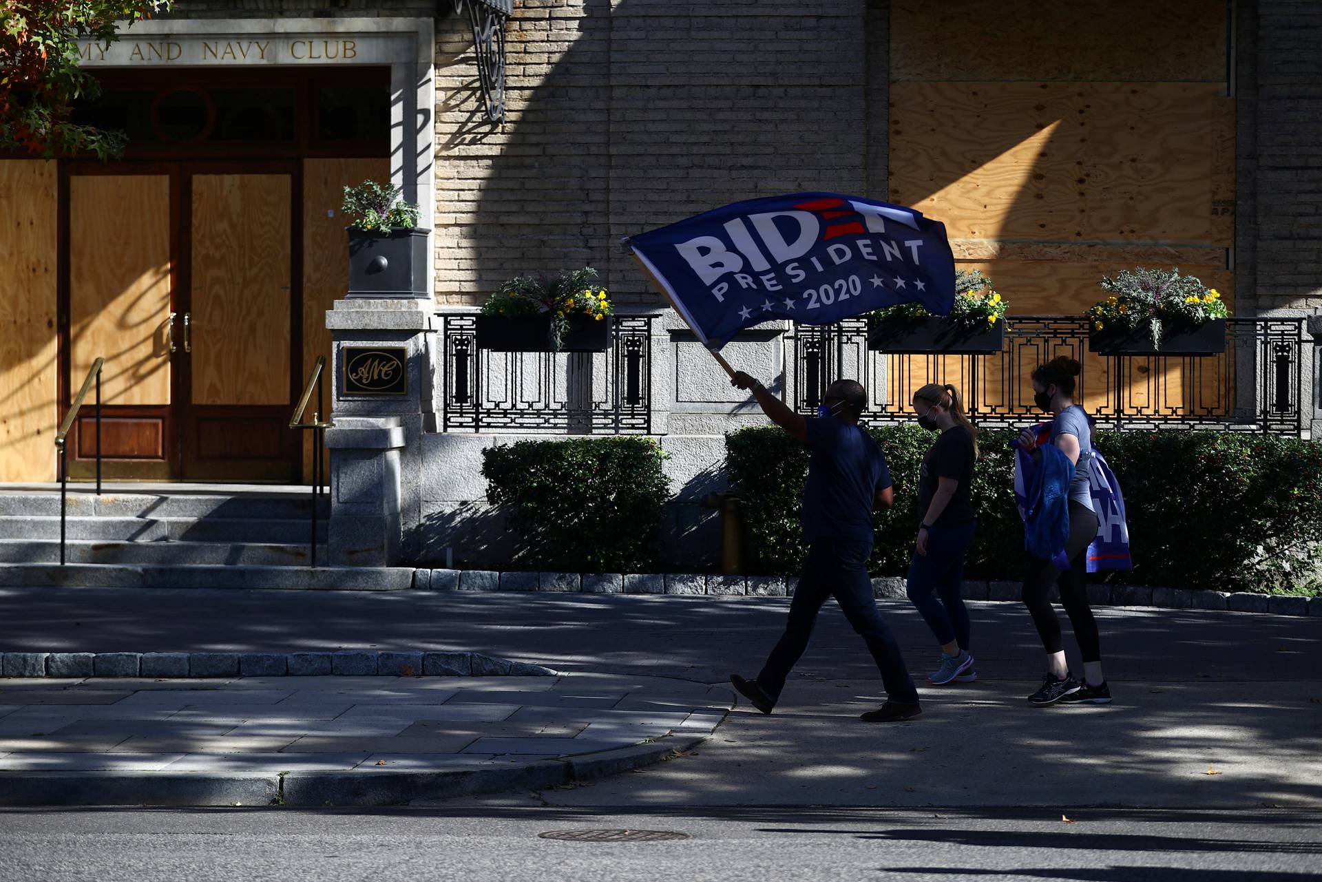 People react as media announce that Democratic U.S. presidential nominee Joe Biden has won the 2020 U.S. presidential election in Washington