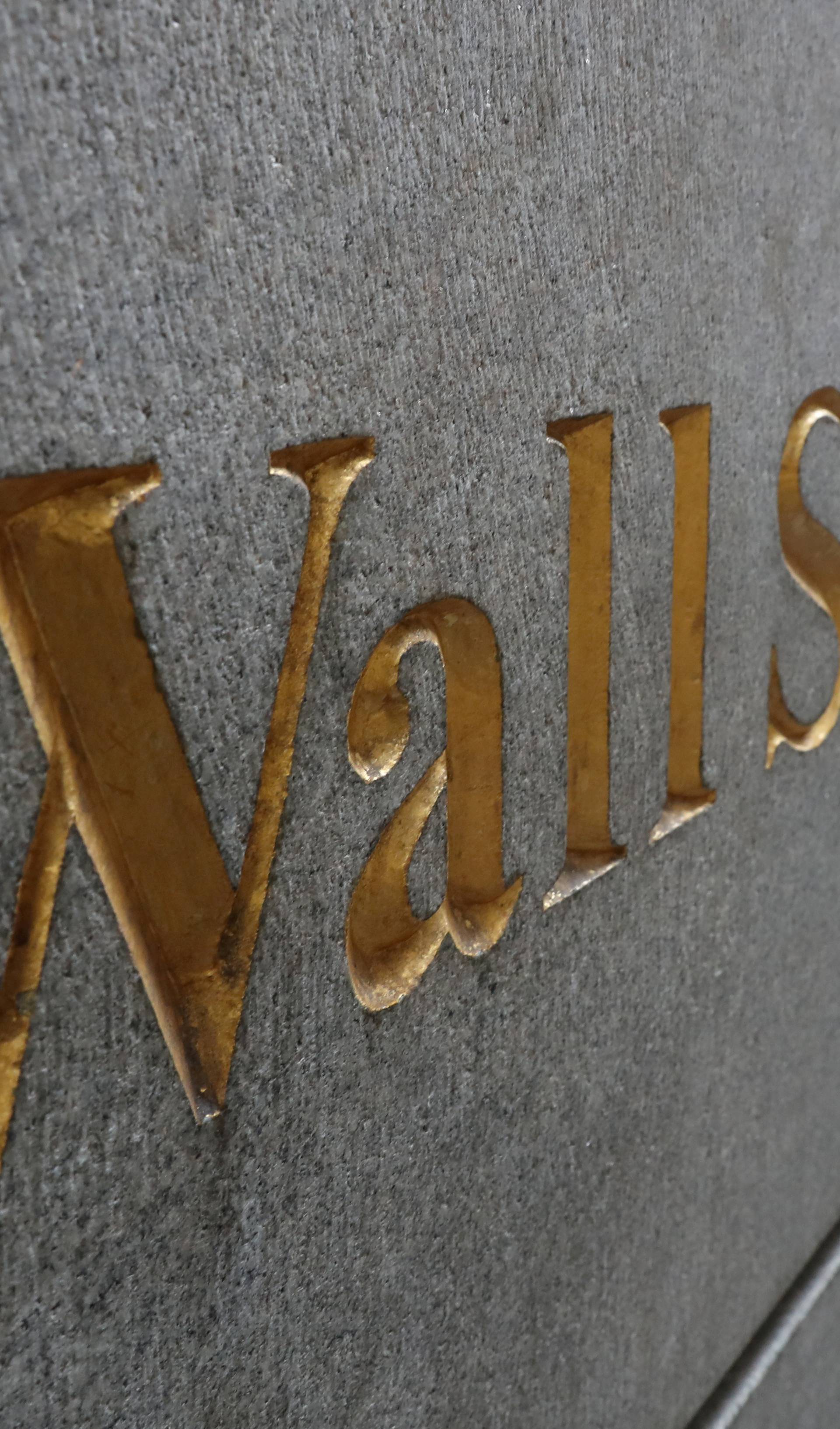 FILE PHOTO: A street sign, Wall Street, is seen outside New York Stock Exchange (NYSE) in New York City, New York