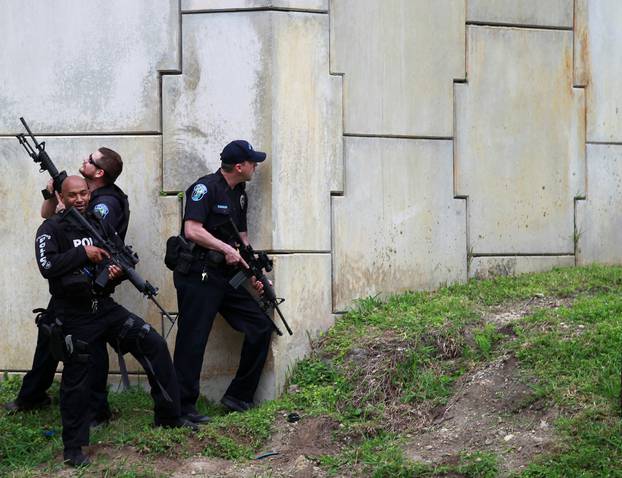 Law enforcement officers are seen as the search for suspects is conducted near the airport perimeter  following a shooting incident at Fort Lauderdale-Hollywood International Airport in Fort Lauderdale, Florida