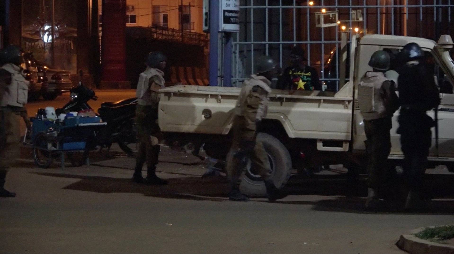 Soldiers are seen at the back of a truck following an attack by gunmen on a restaurant in Ouagadougou, Burkina Faso, in this still frame taken from video