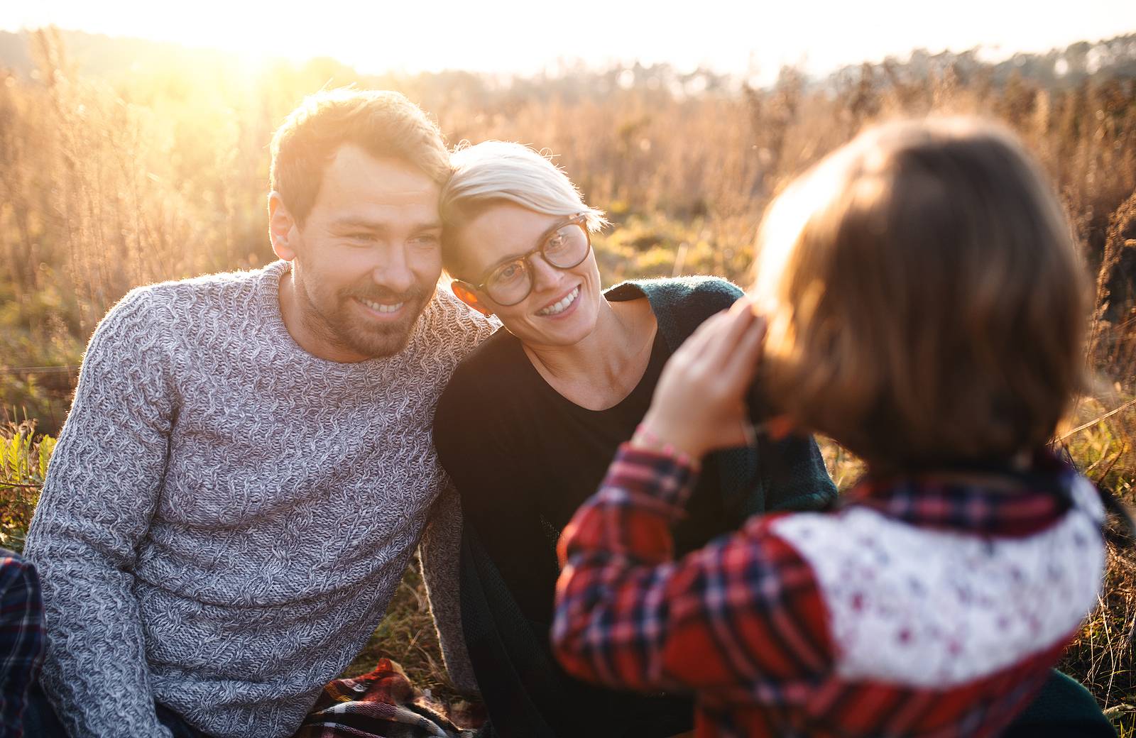 Small Girl With Family On Picnic In Autumn Nature, Taking Photog