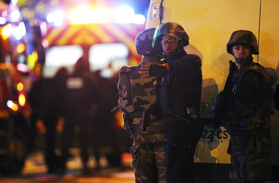 FILE PHOTO: Security forces signal journalists to move back as they secure the area near the Bataclan concert hall following fatal shootings in Paris, France
