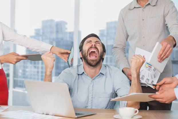 Frustrated business man at a desk yelling