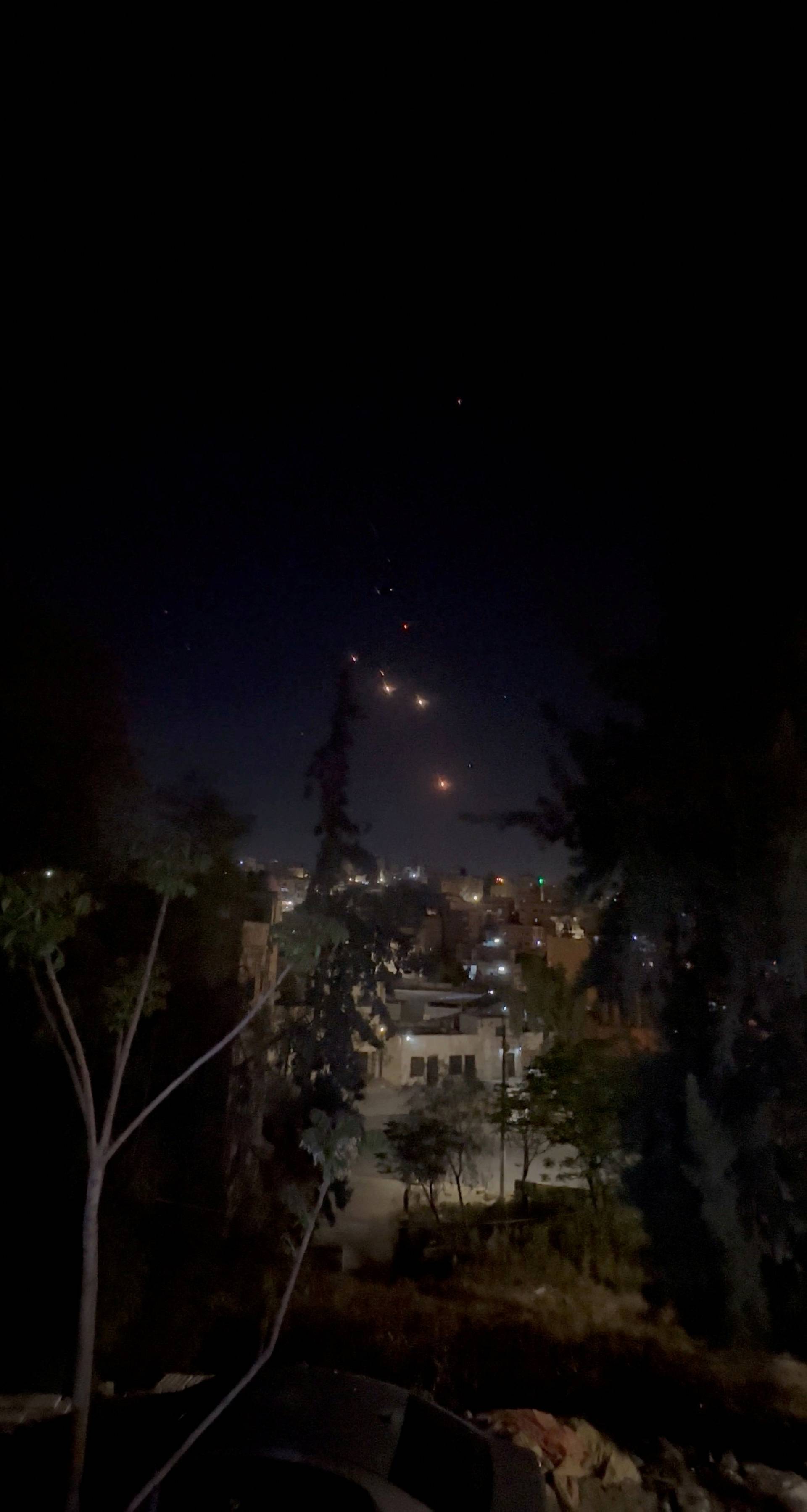 Objects are seen in the sky over Amman after Iran launched drones towards Israel