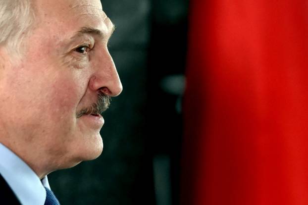Belarusian President Alexander Lukashenko visits a polling station during the presidential election in Minsk