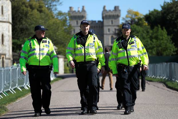 Police officers walk down Long Walk leading away from Windsor Castle before the upcoming wedding of Britain