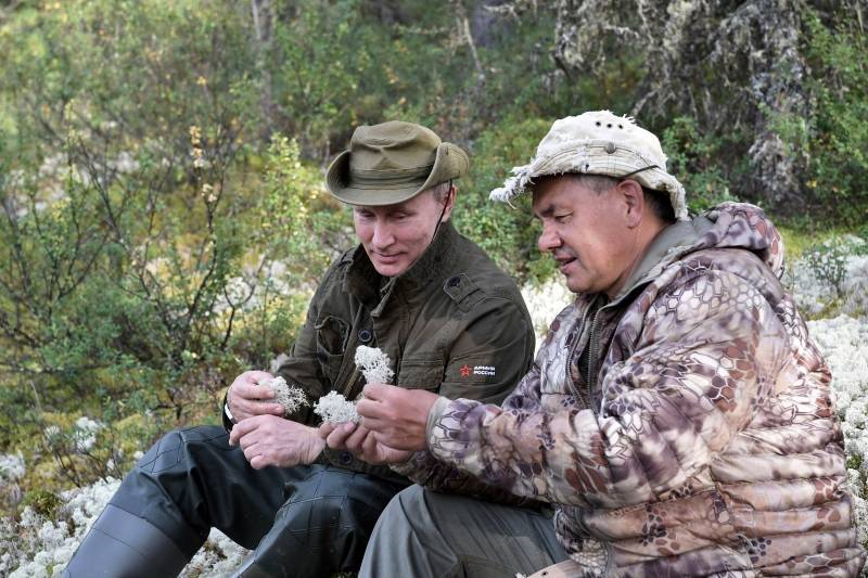 Russian President Vladimir Putin and Defence Minister Sergei Shoigu rest during the hunting and fishing trip which took place on August 1-3 in the republic of Tyva in southern Siberia