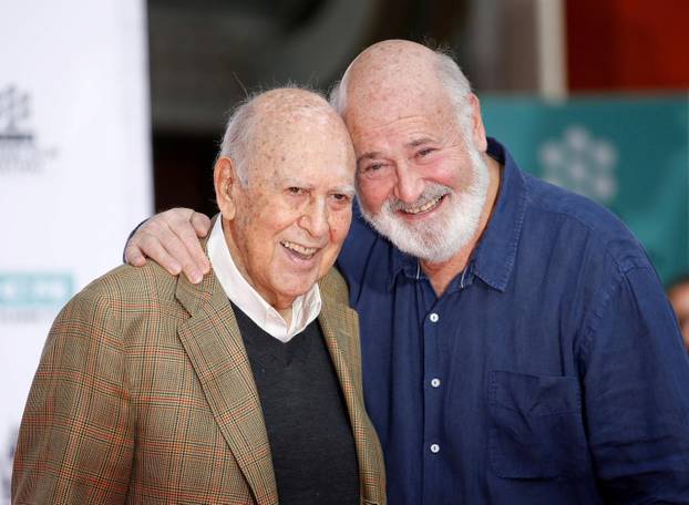 FILE PHOTO: Actors, directors and producers Rob Reiner and his father Carl Reiner pose during their Hand and Footprint Ceremony in Hollywood