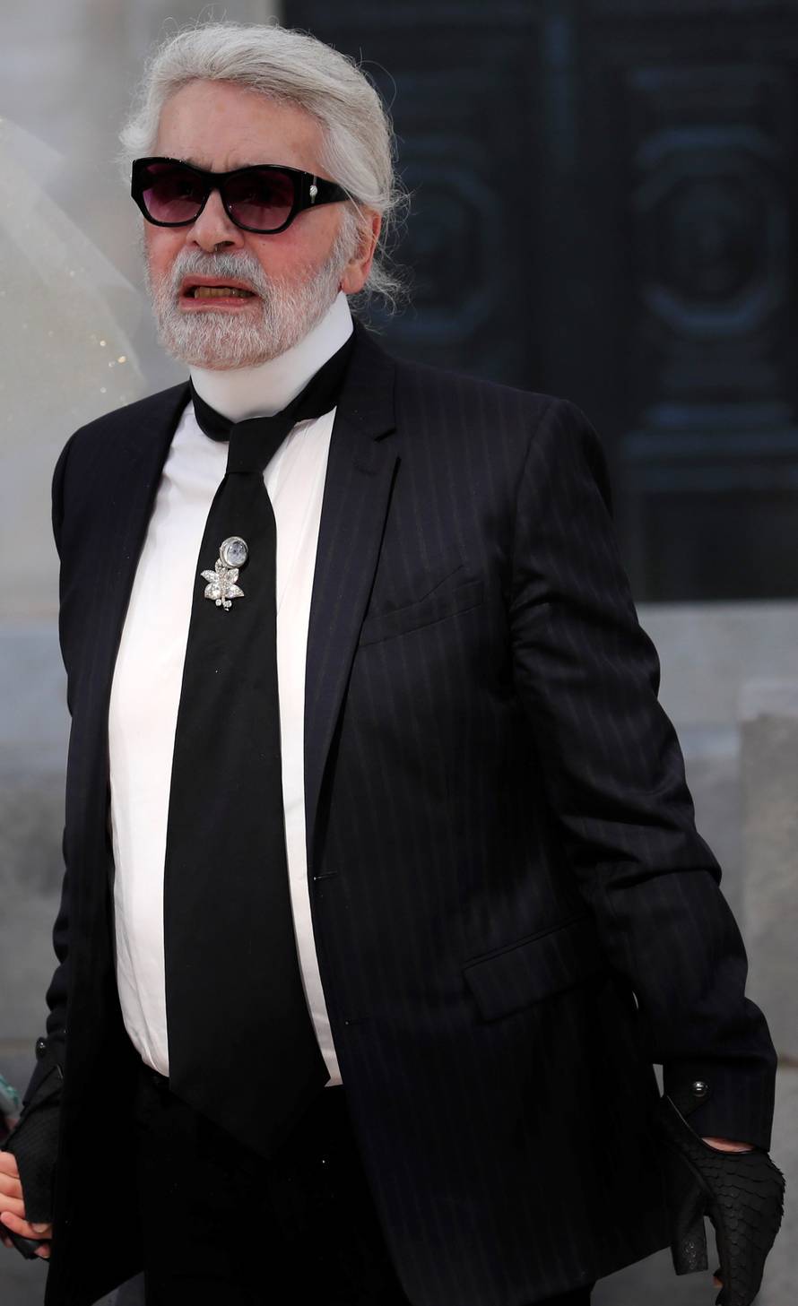 German designer Karl Lagerfeld appears with models at the end of his Haute Couture Fall/Winter 2018/2019 collection show for fashion house Chanel at the Grand Palais in Paris
