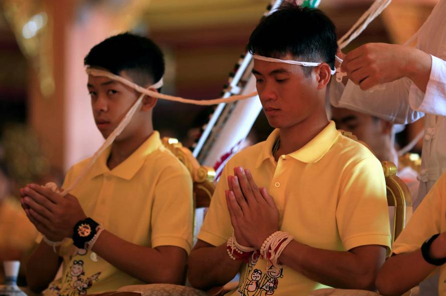 Members of a soccer team rescued from a cave attend a religious ceremony, in a temple at Mae Sai, in the northern province of Chiang Rai