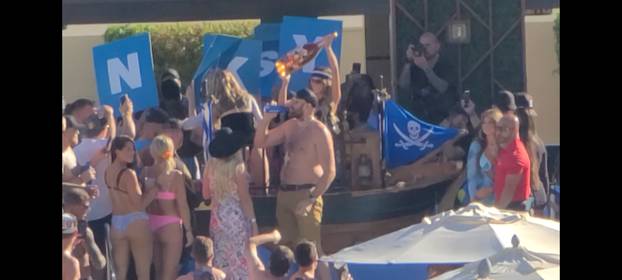 EXCLUSIVE: Tyson Fury parties shirtless as a fan dives into his vip pool as wife Paris and others celebrate his brutal world championship boxing win in Las Vegas