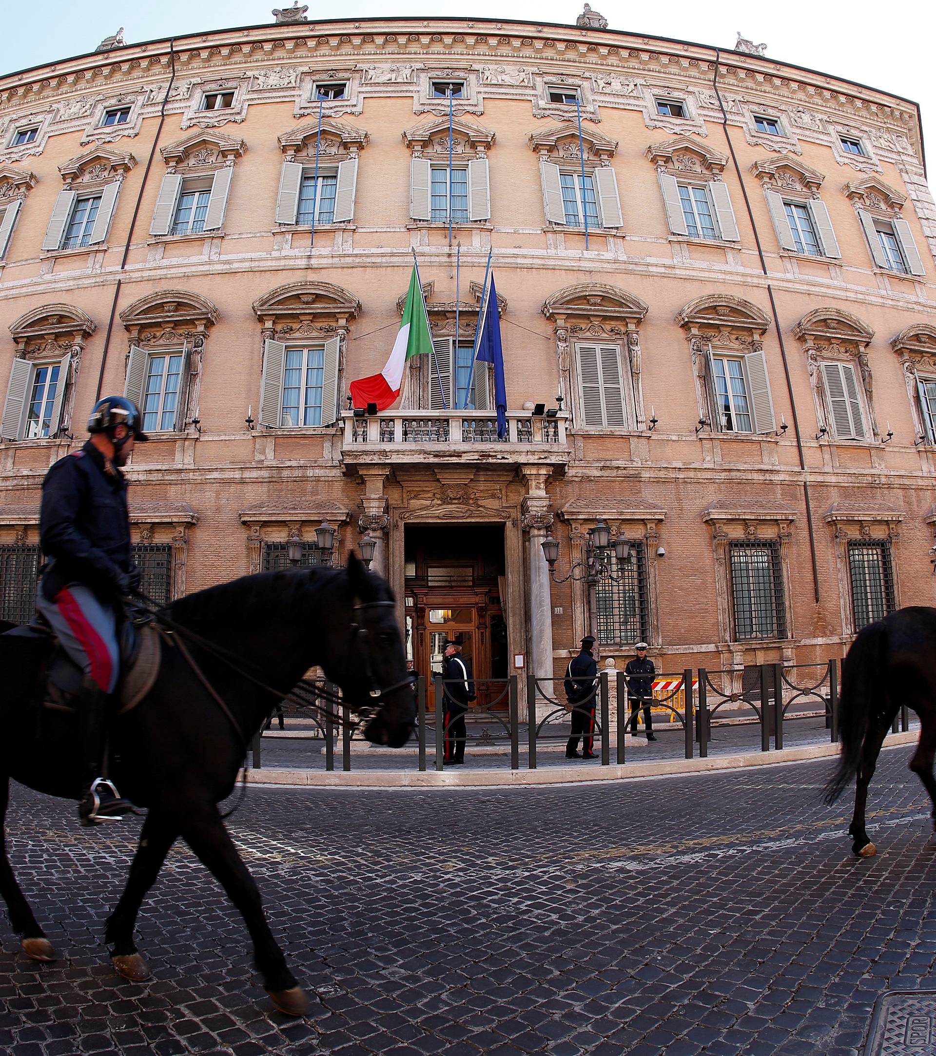 Italian police officers ride horses in front of the Senate prior the opening of the second session day since the March 4 national election in Rome