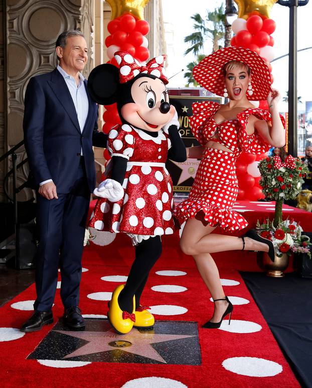 The character of Minnie Mouse poses on her star with singer Perry and Chairman and CEO of The Walt Disney Company Iger after it was unveiled on the Hollywood Walk of Fame in Los Angeles