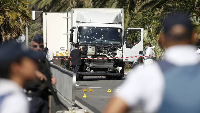 French police secure the area as the investigation continues at the scene near the heavy truck that ran into a crowd at high speed killing scores who were celebrating the Bastille Day July 14 national holiday on the Promenade des Anglais in Nice