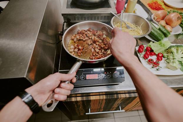 High,Angle,Shot,Of,Unrecognizable,Male,Hands,Holding,Pan,And