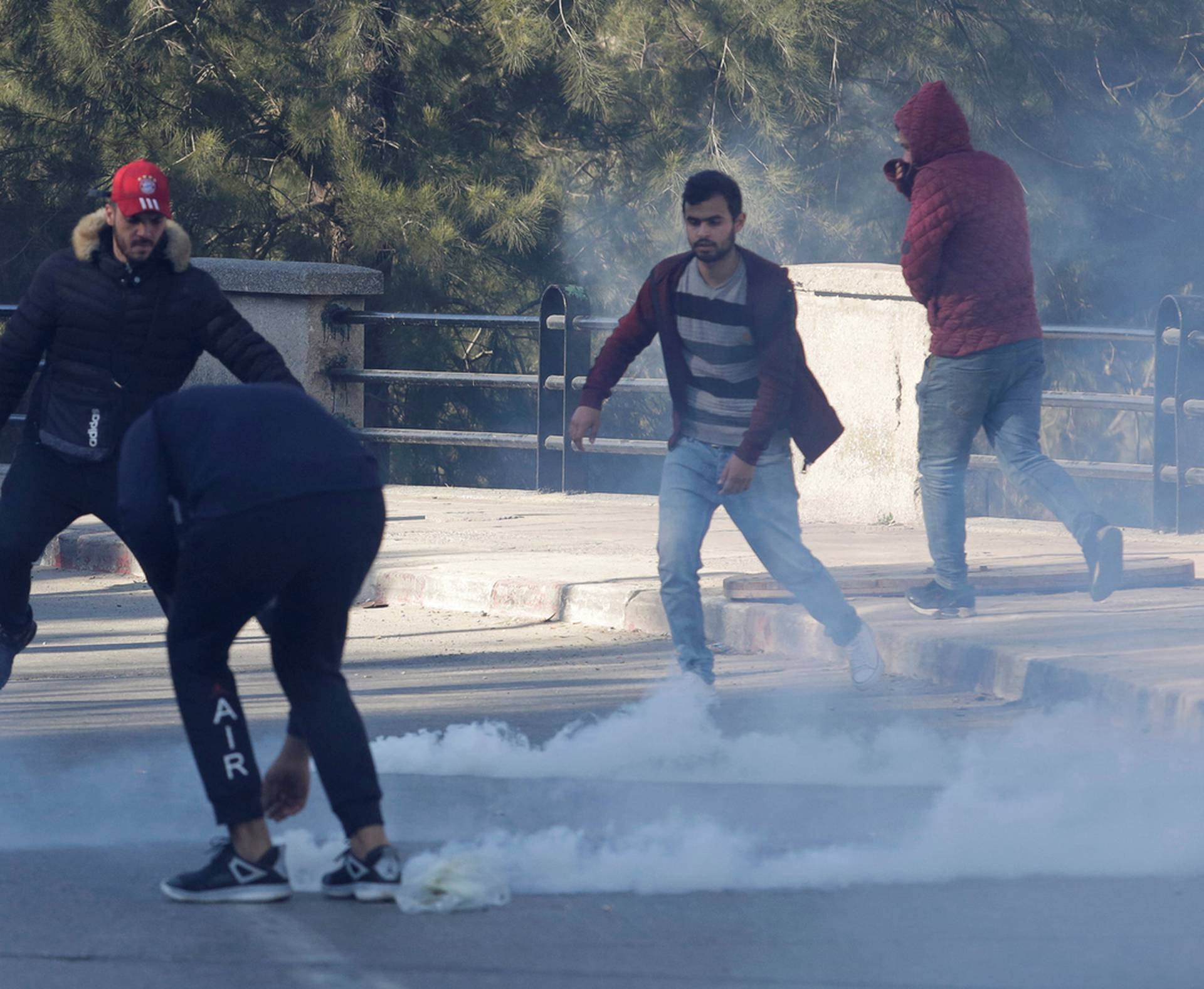 Police use tear gas to disperse crowds as people marched to protest against President Abdelaziz Bouteflika's plan to seek a fifth term in Algiers