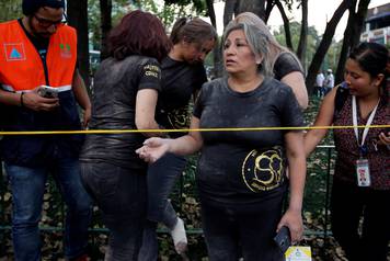 A woman reacts after she and others were rescued after an earthquake hit Mexico City, Mexico
