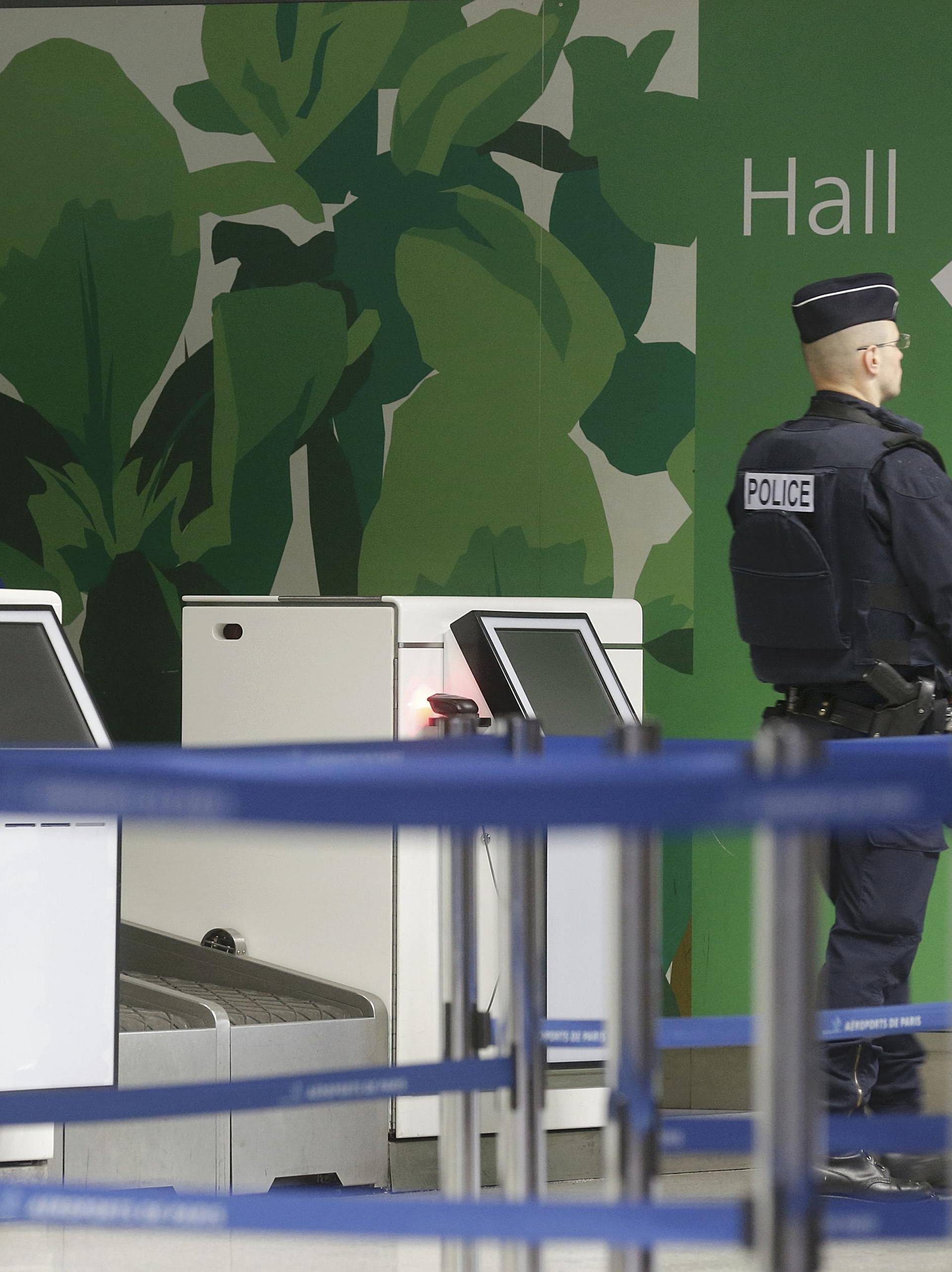 A policeman stands guard at Charles de Gaulle airport in Paris