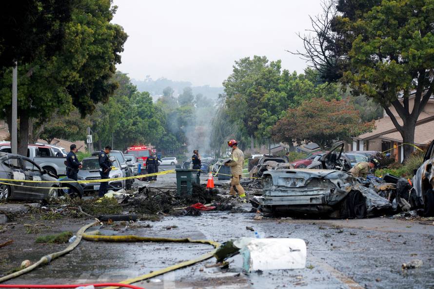 Crash scene after a civilian aircraft went down in a neighborhood, in San Diego