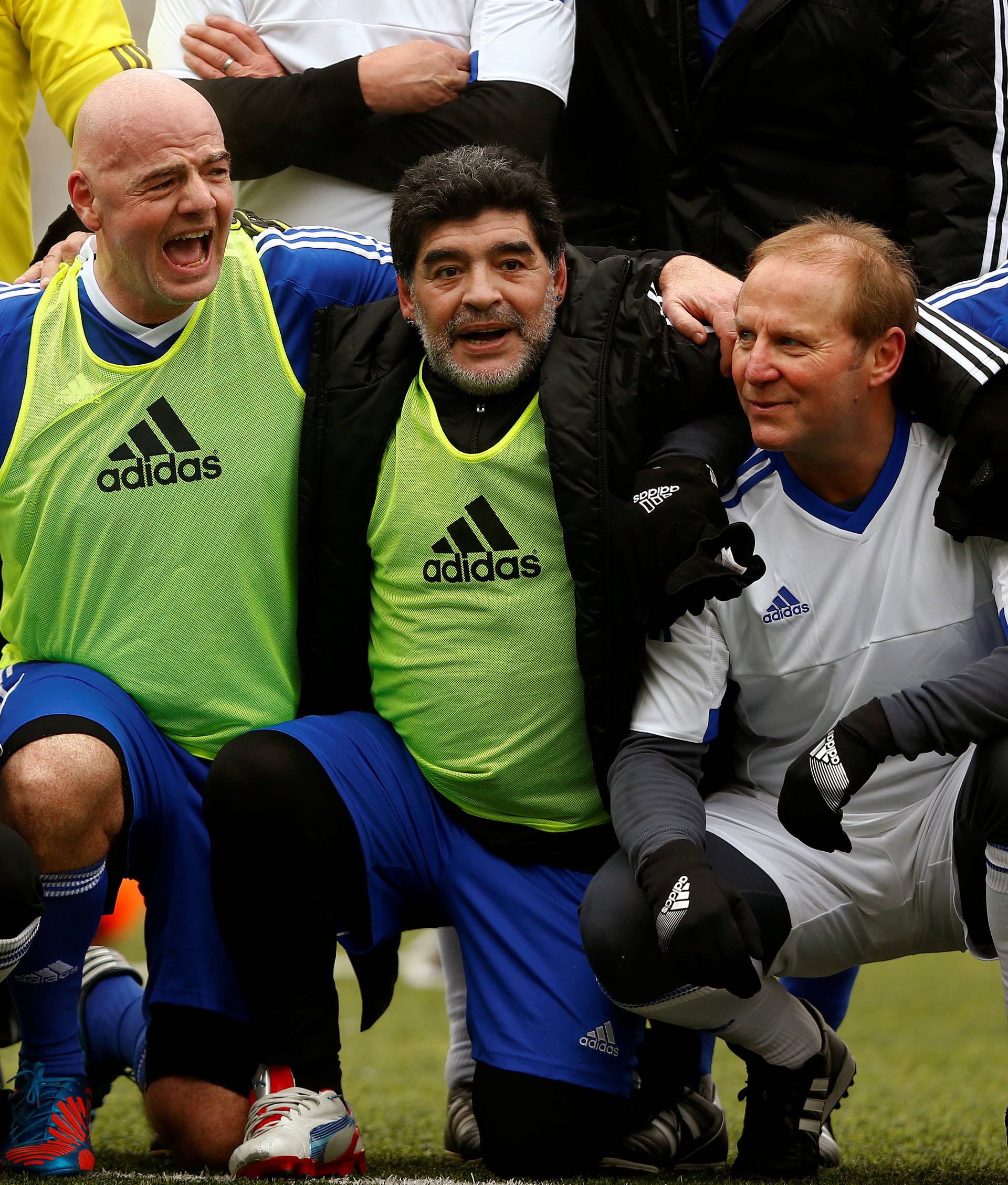 Maradona and FIFA President Infantino pose with team members after the FIFA Legends tournament in Zurich