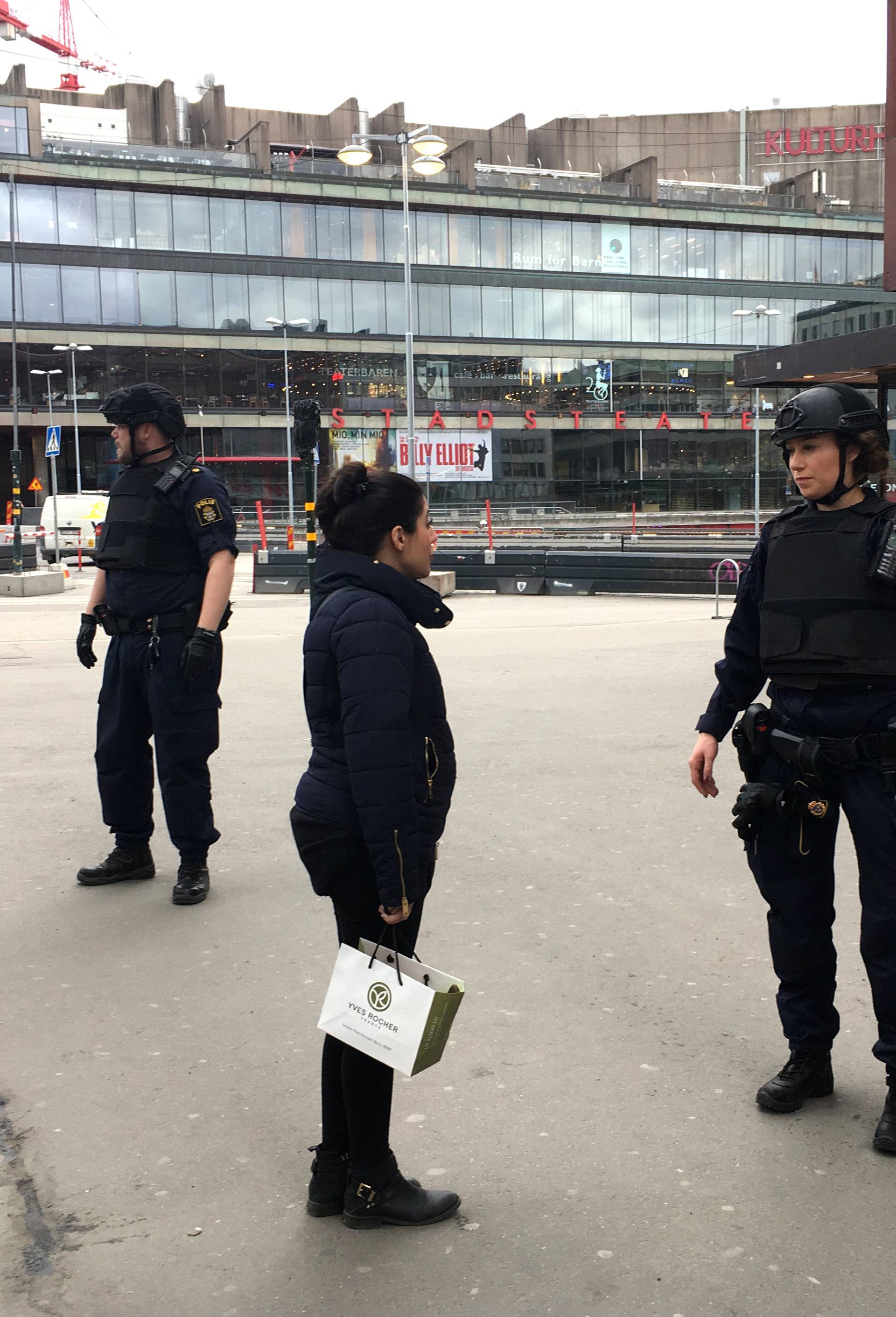 Police officers stand in the centre of Stockholm