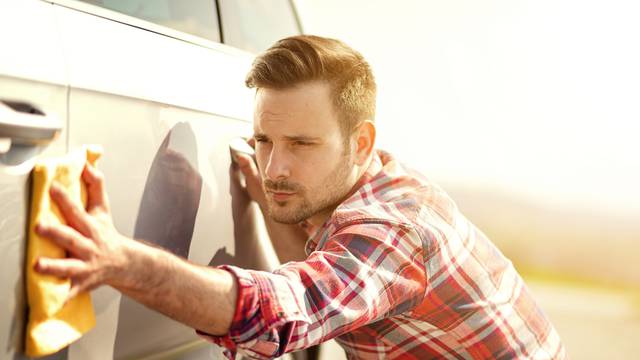 Young,Man,Cleaning,His,Car,Outdoors.man,With,A,Microfiber,Wipe