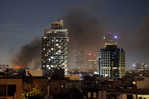 Smoke rises following an Iranian projectile strike in Tel Aviv