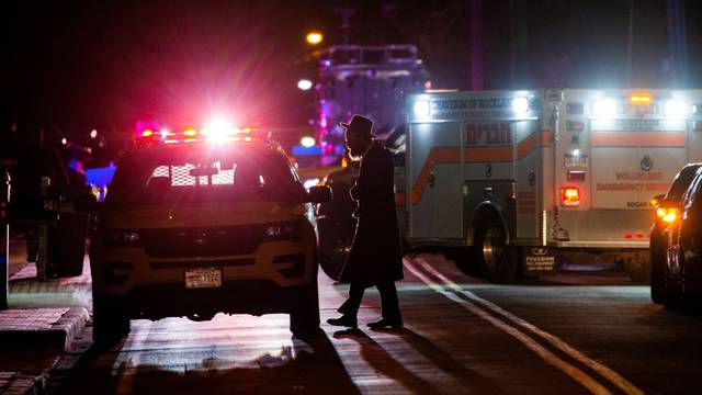 A Jewish man walks near the area where 5 people were stabbed at a Hasidic rabbi's home in Monsey, New York