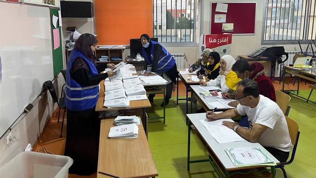 Electoral workers count ballots after polls closed during Lebanon's parliamentary election, in Khiam