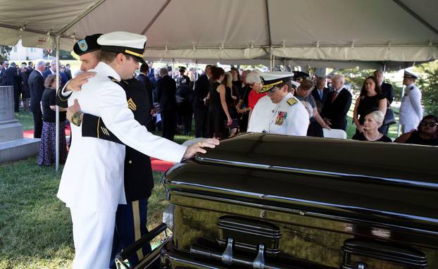 Jimmy McCain hugs his brother Jack during a burial service for McCain in Annapolis
