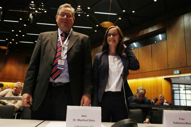 Representatives of VW prepare before the start of a hearing over the VW diesel emissions cheating scandal, in Braunschweig