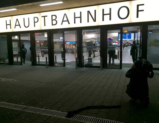 A cameraman films the entrance of the Duesseldorf main train station