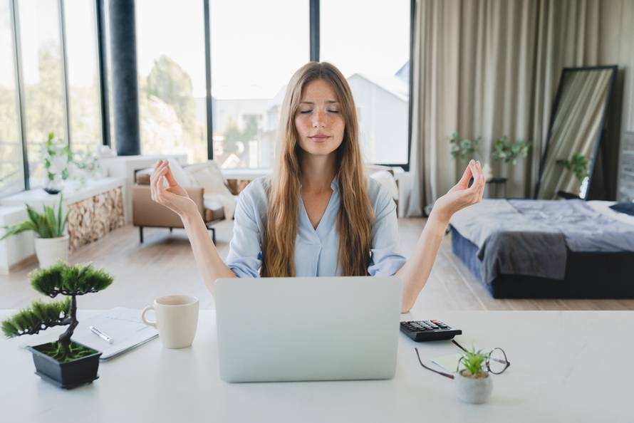 Caucasian,Tired,Woman,Meditating,While,Working,On,Laptop,At,Home