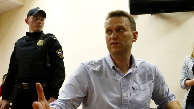 Russian opposition leader Navalny talks to journalists during a hearing at a court in Moscow