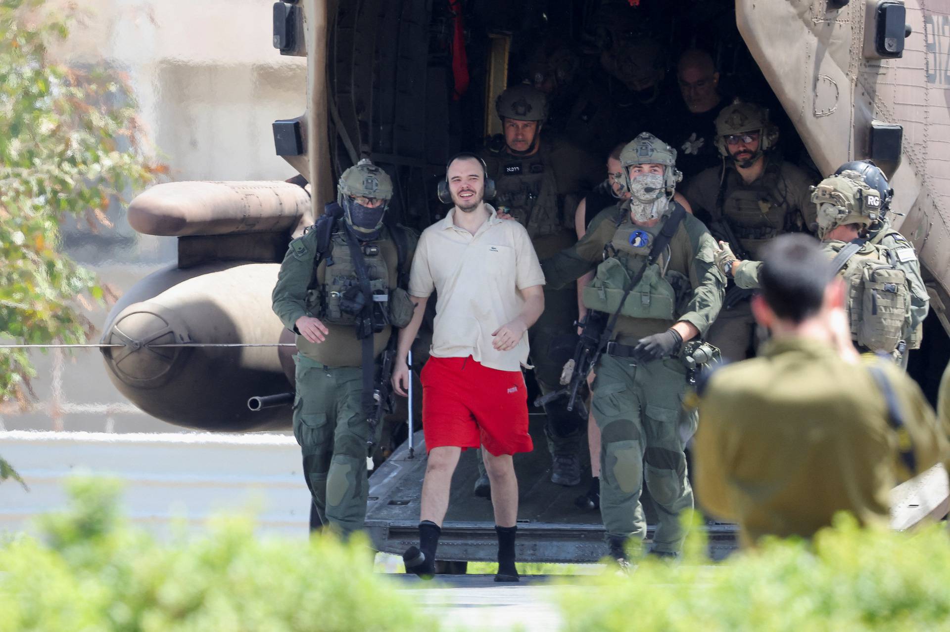 Families of hostages walk towards a hospital to meet with alleged released hostages, in Ramat Gan