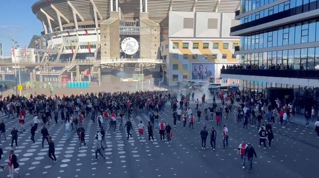 Police officers use teargas to disperse football fans rioting Johan Cruijff Arena