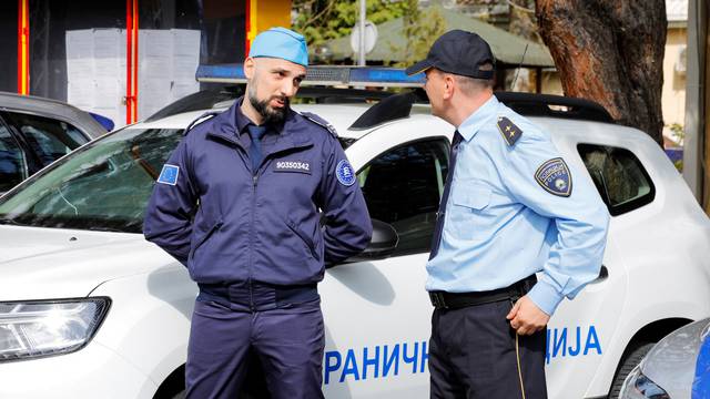 A member of FRONTEX talks with a Macedonian policeman during the ceremony for the official start of the joint border control with Macedonian police in Skopje