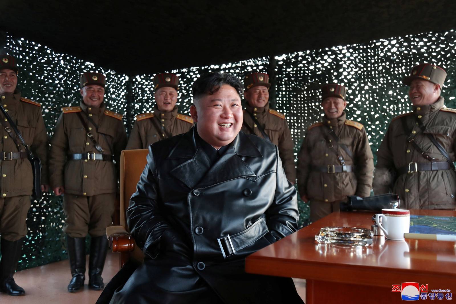 North Korean leader Kim Jong Un observes the firing of suspected missiles