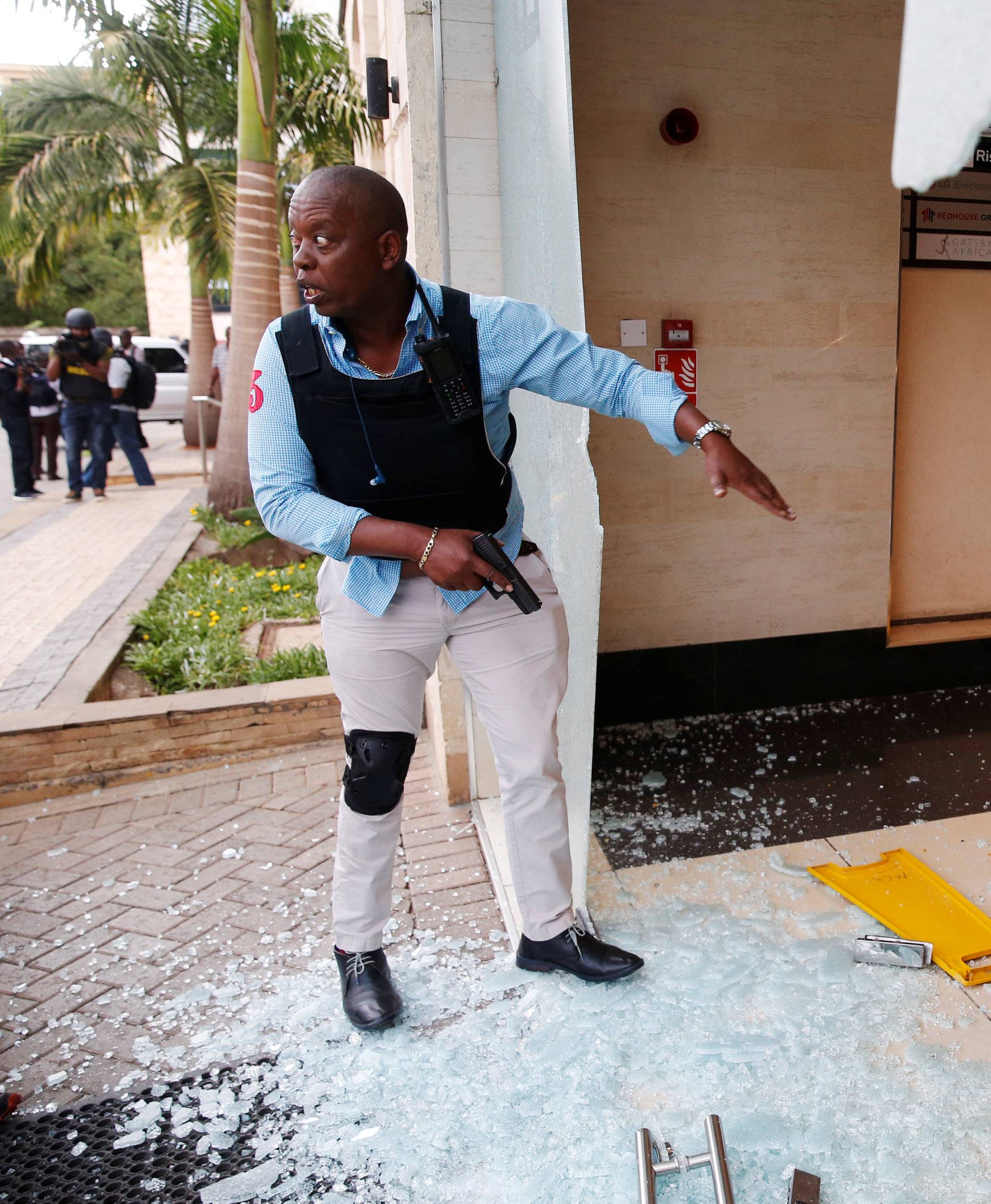 A policeman takes position at the scene where explosions and gunshots were heard at the Dusit hotel compound, in Nairobi