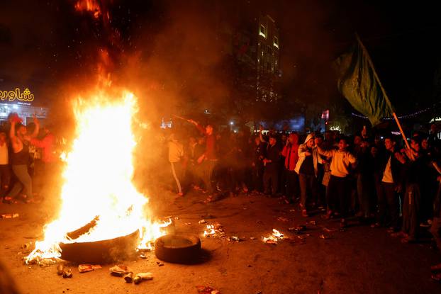 Palestinians celebrate following Jerusalem's shooting attack, in Gaza City