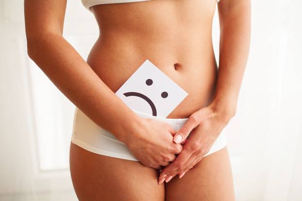 Woman Health. Female Body Holding Sad Smiley Card Near Stomach.