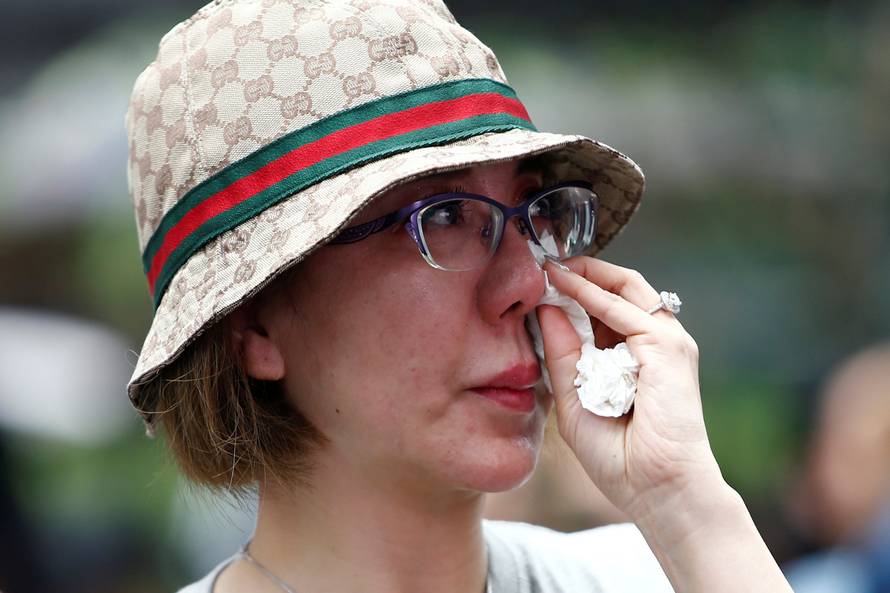 Family member wipes her tears away during fourth annual remembrance event for missing MH370, in Kuala Lumpur