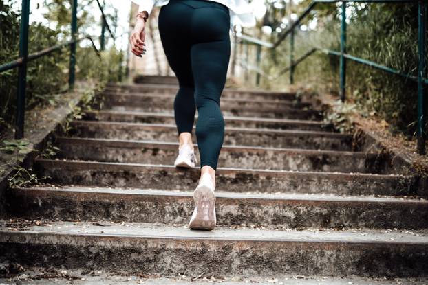 photo of a sport girl going up on stairs