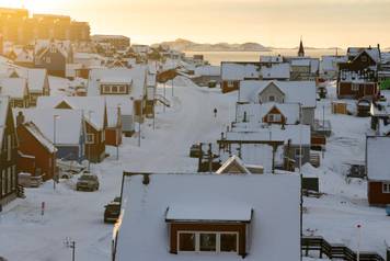 A person walks along a street on the day of the meeting between top U.S. officials and the foreign ministers of Denmark and Greenland, in Nuuk