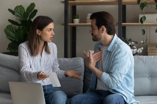 Angry wife and husband arguing about unexpected debt or expenses