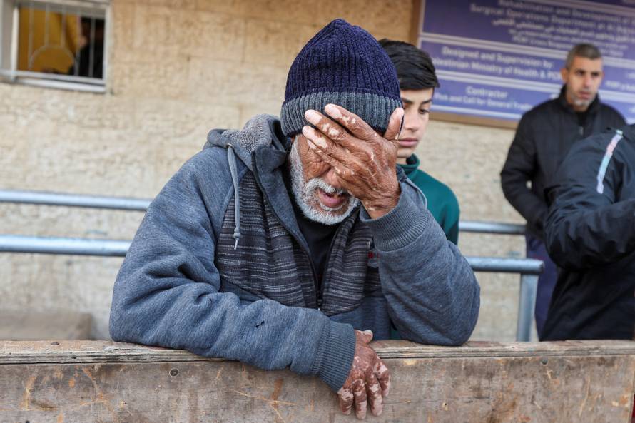 Palestinians mourn loved ones killed in Israeli strikes, in Deir Al-Balah in the central Gaza Strip