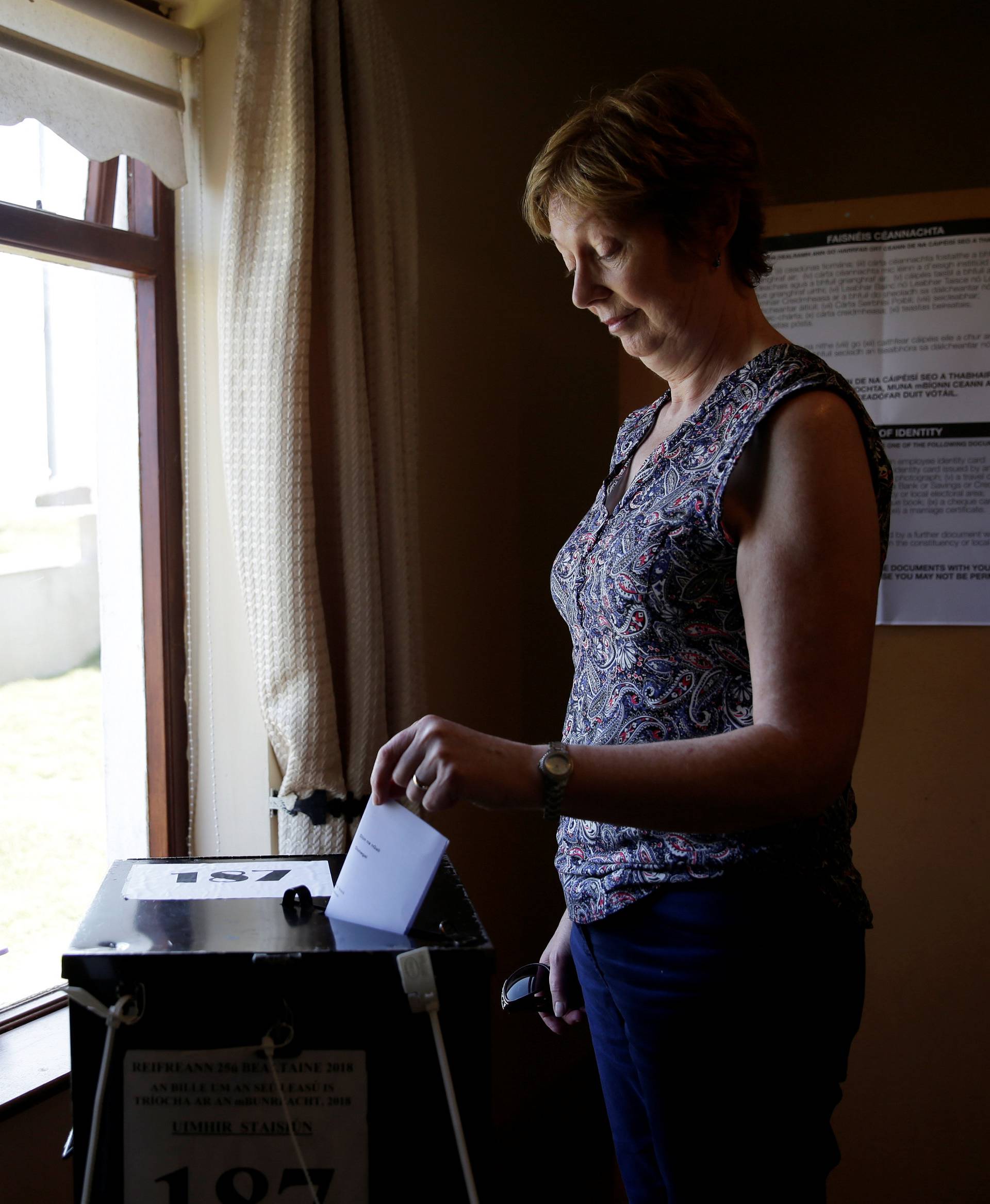 A woman casts her vote in Ireland's referendum on liberalizing abortion law, on Gola Island