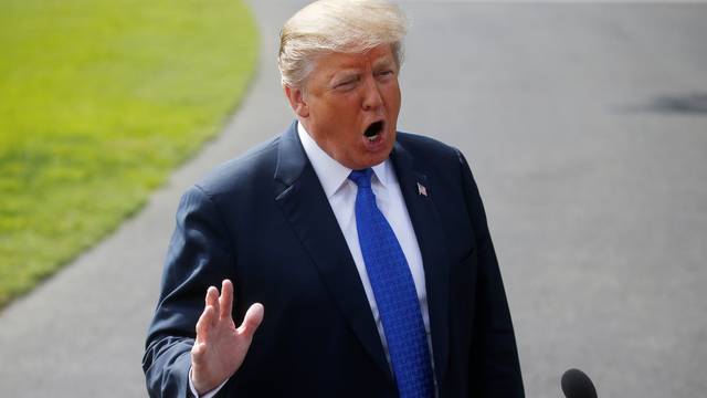 U.S. President Donald Trump speaks to the news media as he makes his way to Marine One for travel to Pennsylvania at the White House in Washington